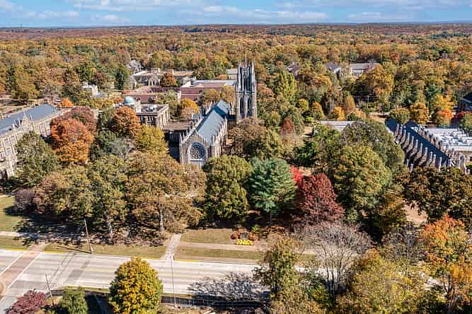 The University of the South in Sewanee Tennessee aerial view of the tower, chapel and the observatory on the Cumberland Plateau Mountain. Beautiful October autumn day with fall colorful foliage in the background