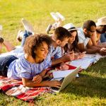 College students studying together outside during summer programs
