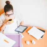 Young woman studying and drinking coffee