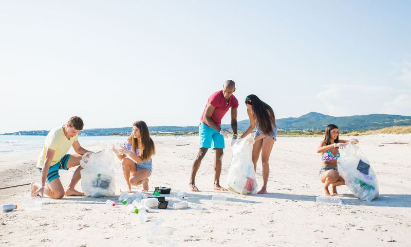 Six students collect litter from the beach for a community service project