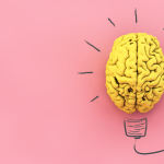idea concept: yellow brain on pink background