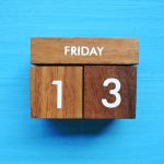 An image of a wooden block calendar with Friday the 13th