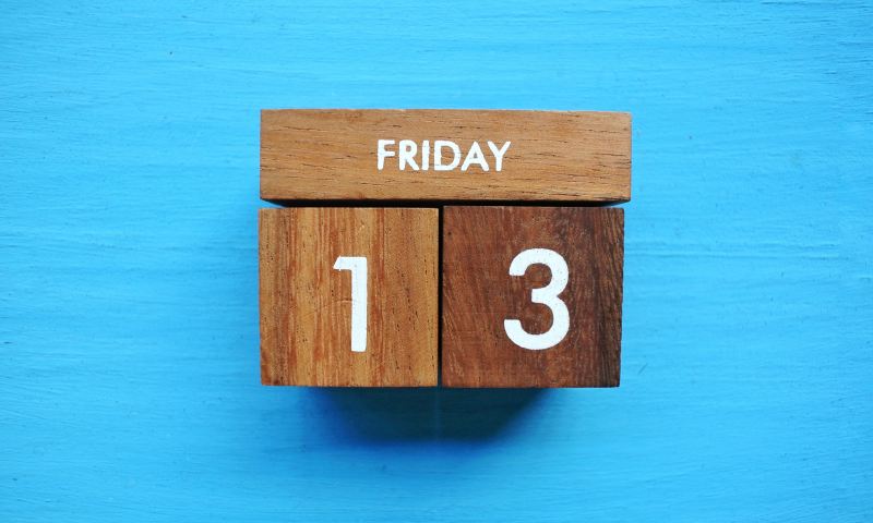 An image of a wooden block calendar with Friday the 13th