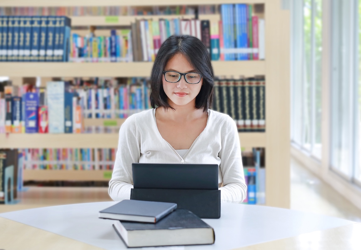 woman on a laptop in a library
