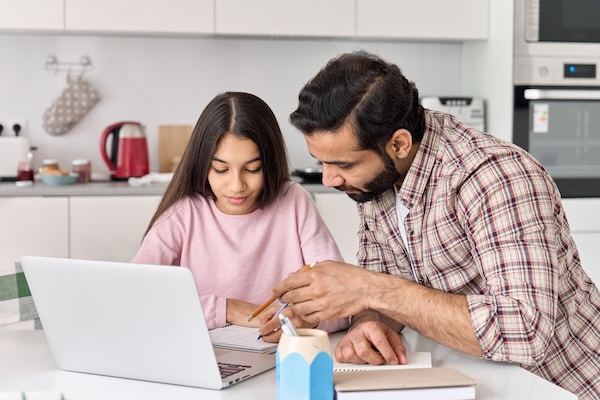 dad helping young daughter during study time