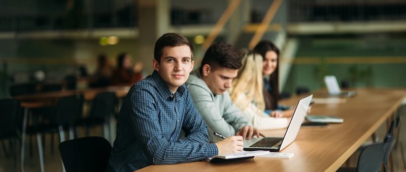 Group of college students studying in the school library