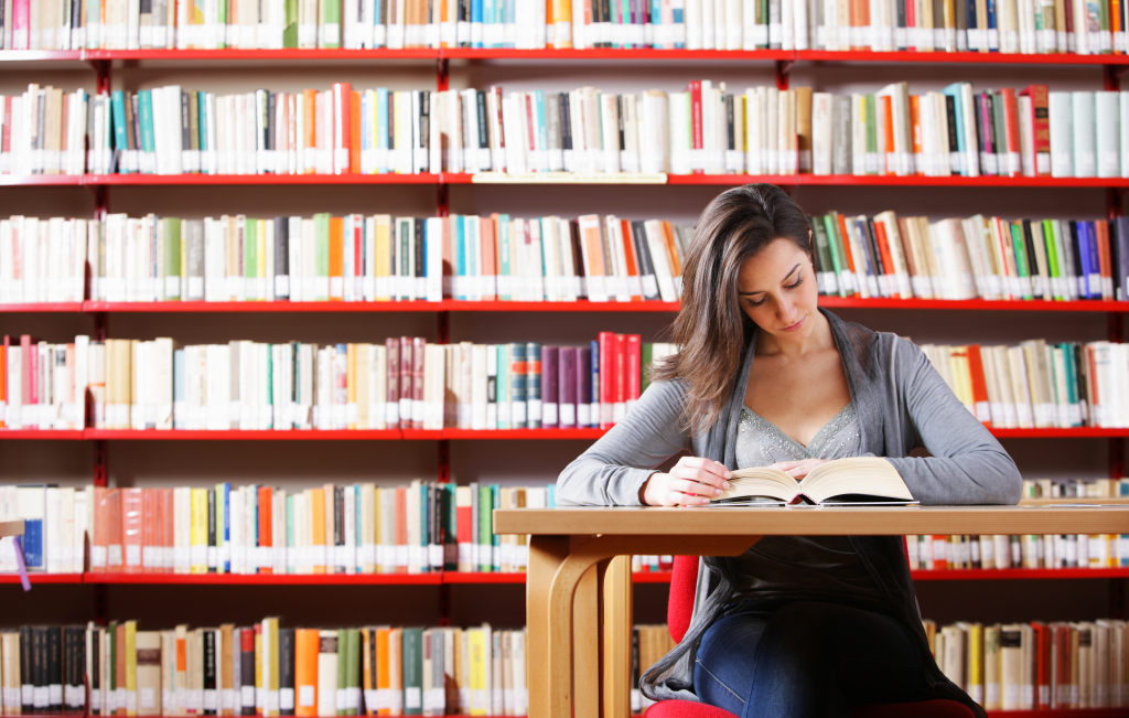 female high school student studying at library