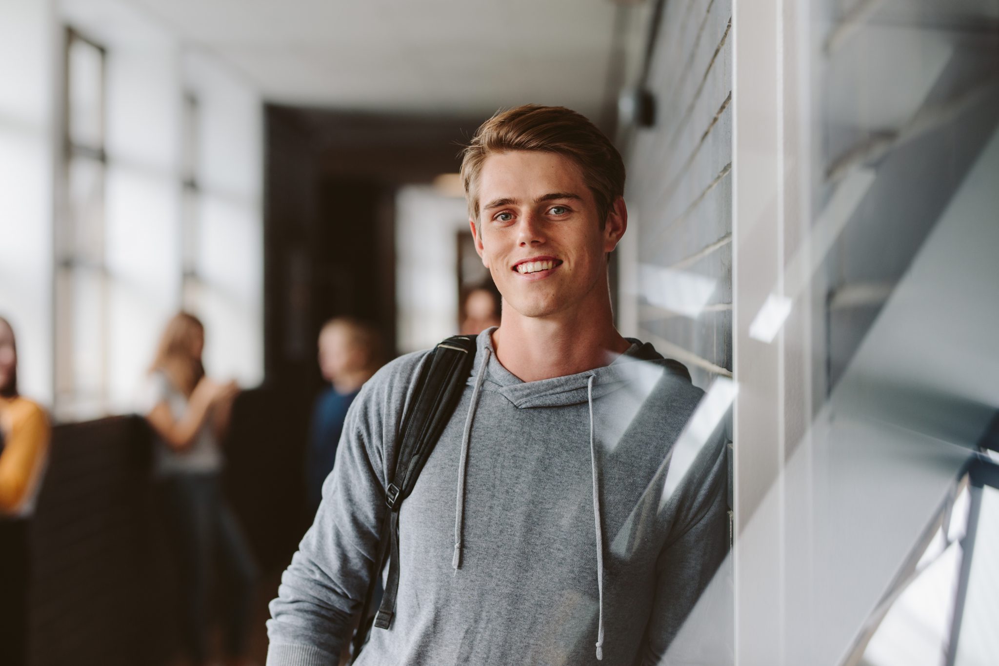 male student with a backpack on campus