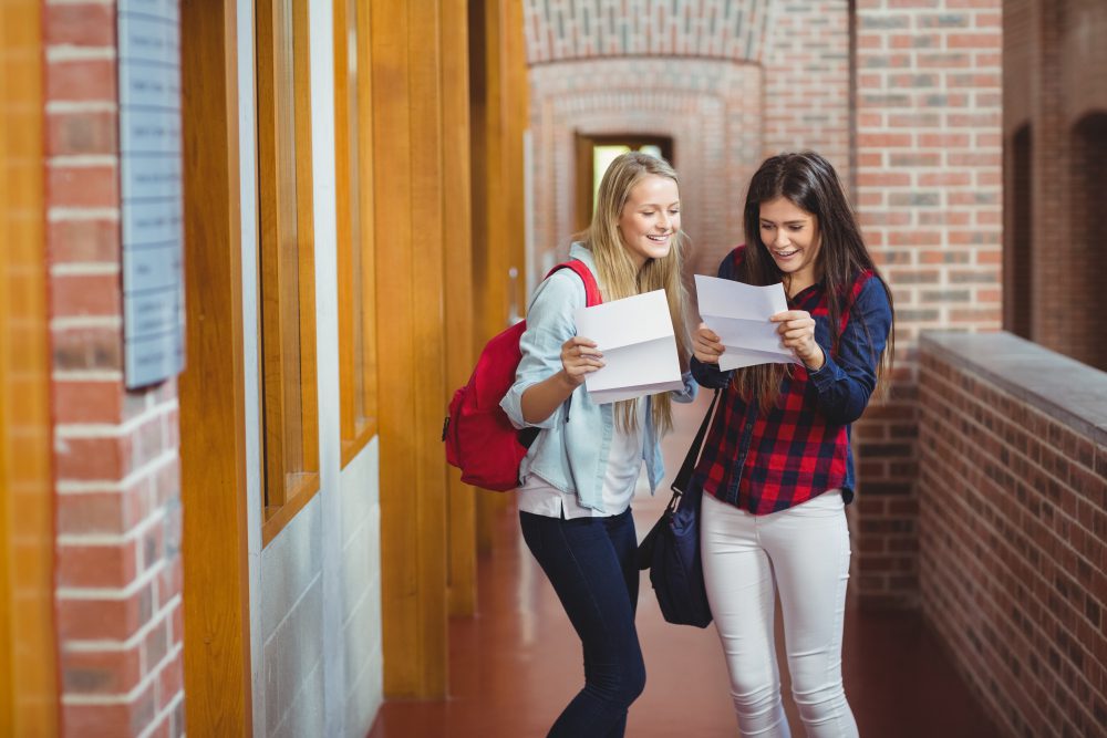 Smiling students looking at good ACT scores