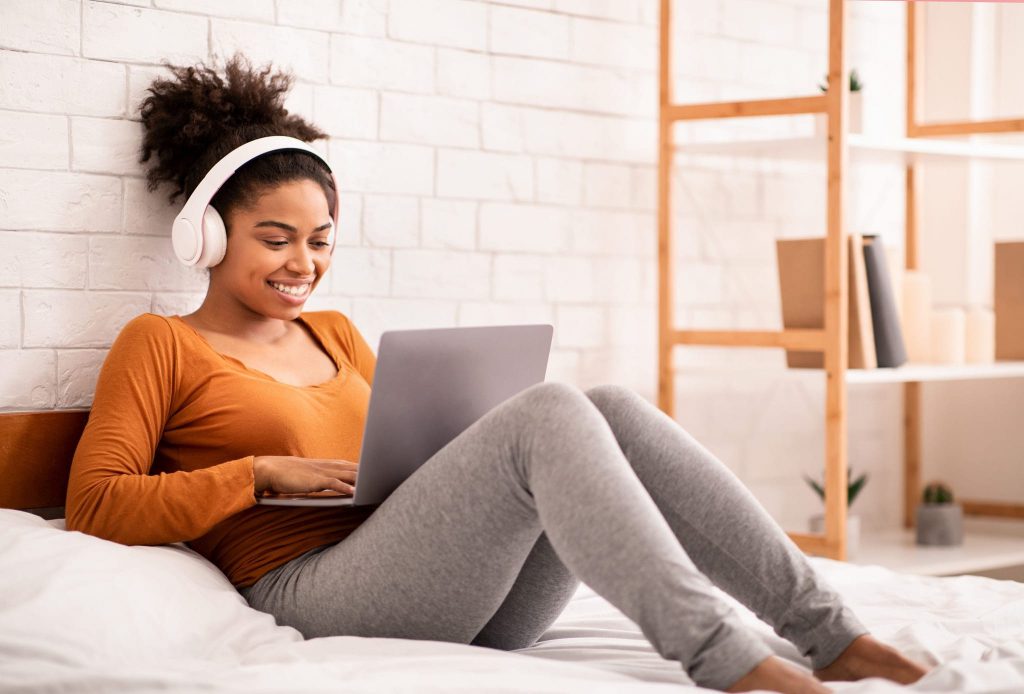 Teenage student on laptop writing Common App activity descriptions