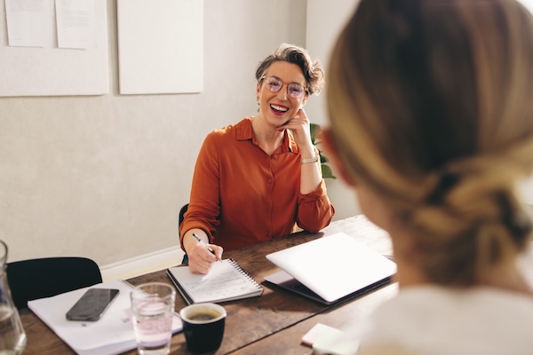 female teacher talking to female student