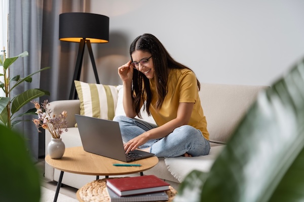 teenage girl writing on laptop