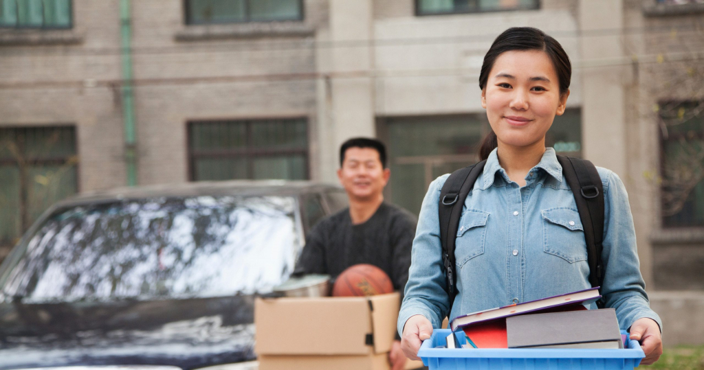 Student and parent moving into college dorm