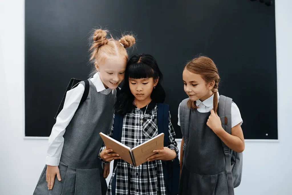 Students Looking at Book