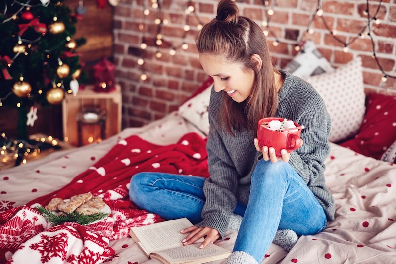 Student reading a book during winter break