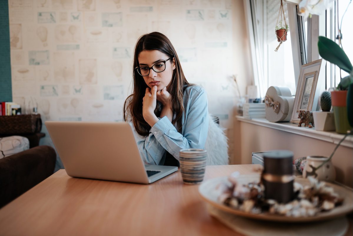 Teen girl looking at her laptop