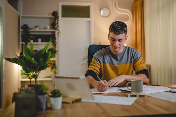 student sitting at desk writing